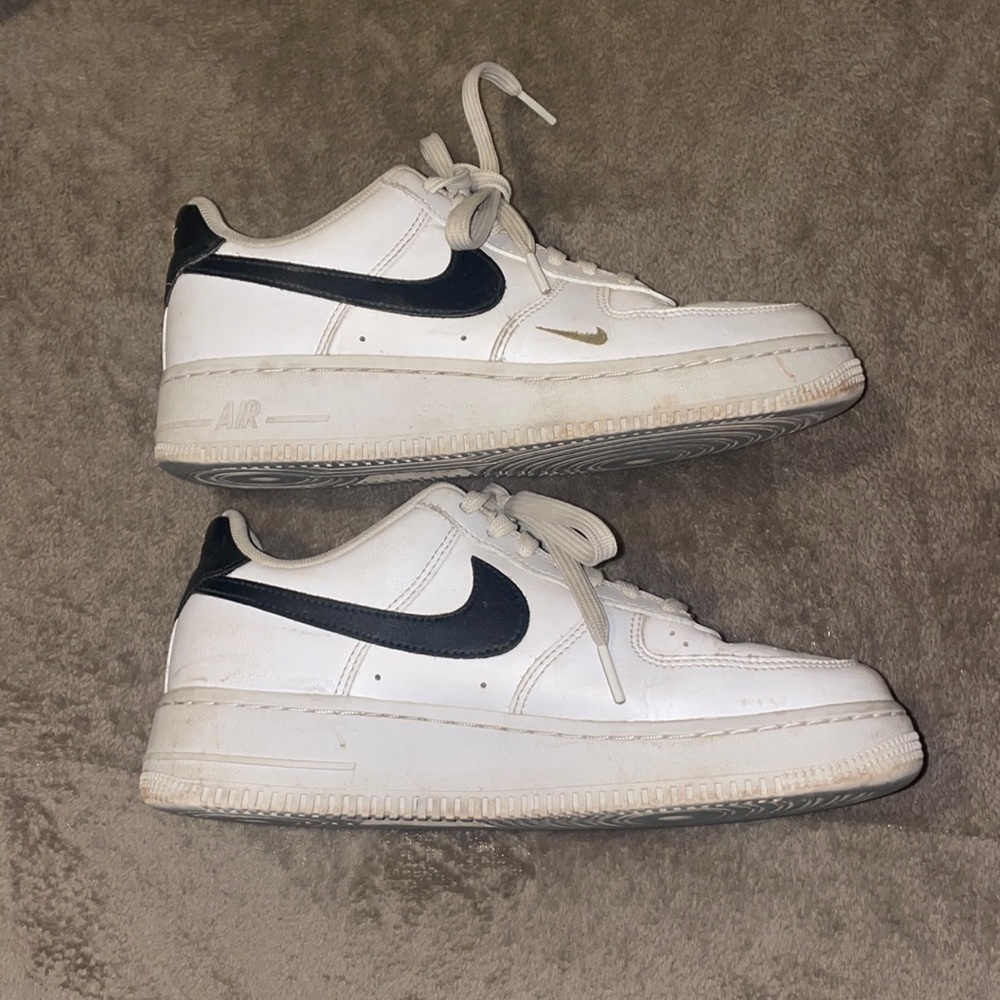 Black and white Nikes with gold